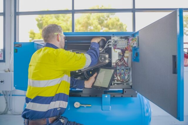 A NPS Service Technician services a compressed air system.